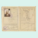 Open passport with photo, stamps and handwritten entries