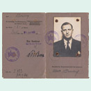 Two pages of an open identification document with handwritten entries, stamps and a passport photo of a young man in a suit.