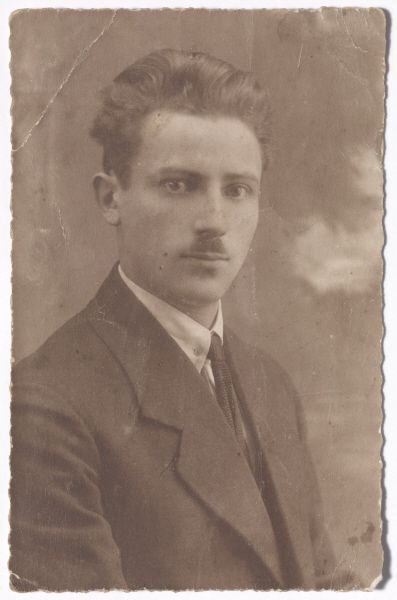 Black-and-white portrait photo of a young man with a moustache in a suit