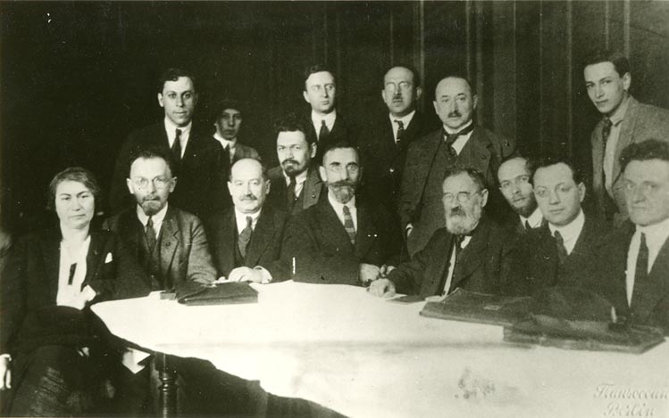Group of men with briefcases  at a desk