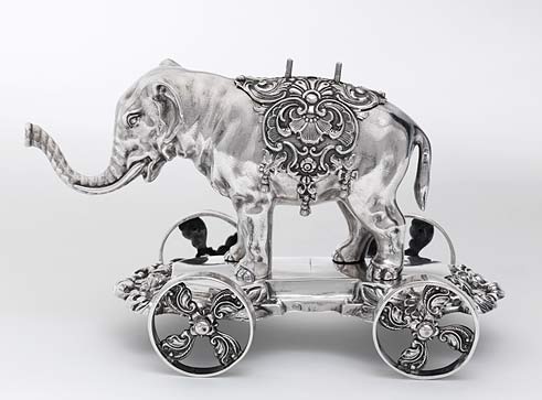 Silver-colored elephant on wheels