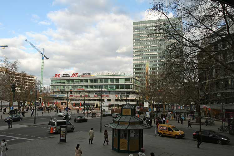 View of the square with people, cars, and buildings
