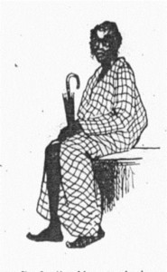 A dark-skinned man sits with an umbrella