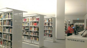 A reading room visitor gets advice from the librarian at the information desk.