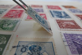 A stamp after renewed adhesion of the paper hinge.
