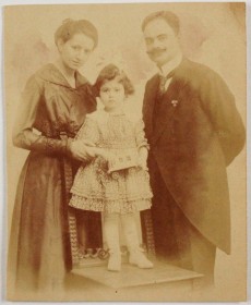 Studio portrait of a woman and a man with a child, about four years old