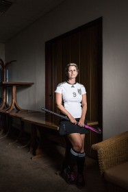 Young woman with hockey stick