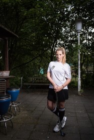 Young woman with hockey stick