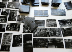 Glass plates with black paintings of furniture on a table