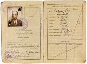 Open passport with a photo of a man with glasses on the left side