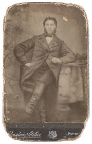 Black and white photo of an man sitting at a table