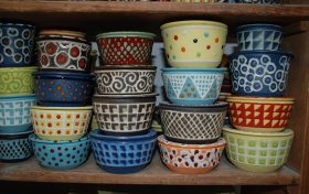 Colorful bowls in a wooden cupboard