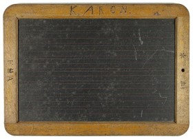 A blackboard with wooden frame with the inscription "K. Aron"