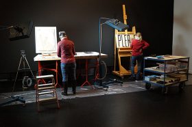 Two conservators in the exhibition