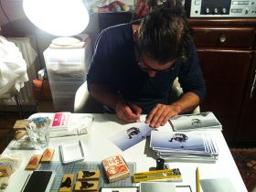 Benjamin Seide signing the cards in Birgits apartment