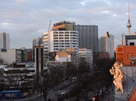 Photography: in the background, the Springer building and television tower, in the foreground a figure from the roof of the Jewish Museum Berlin’s old building.