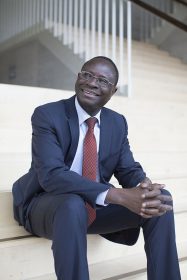 Portrait of Diaby sitting on a staircase