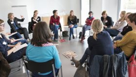 Photo of a discussion group sitting in a circle.