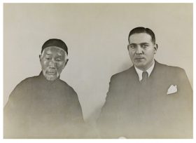 Black-and-white photograph of one Chinese and one European looking man