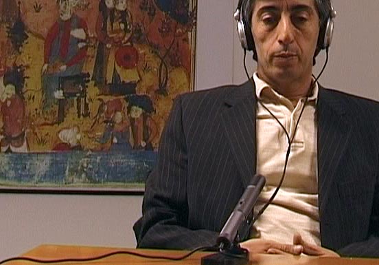 Man with headphones in front of a microphone 