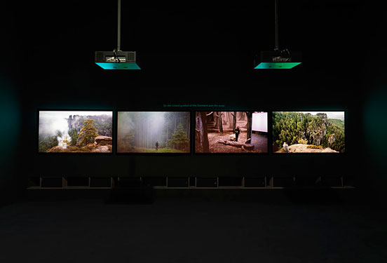 dark room with four monitors showing films