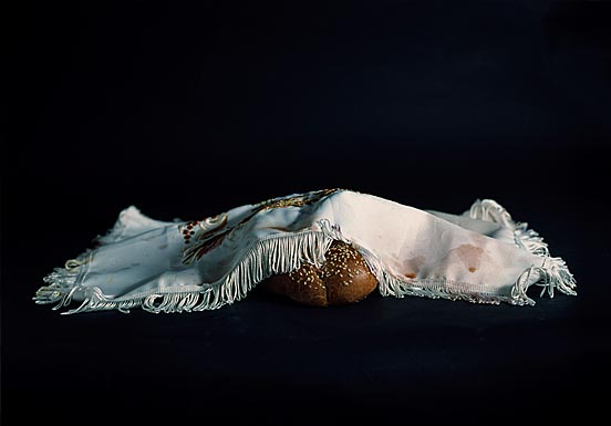 Photo of a loaf of bread covered with a cloth 