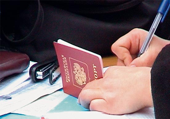 Hands holding a passport and pen