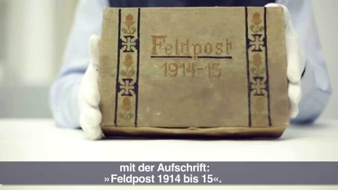 Eine Schachtel beschriftet mit: Feldpost 1914-15 und mit Ornamenten und Kreuzen verziert.