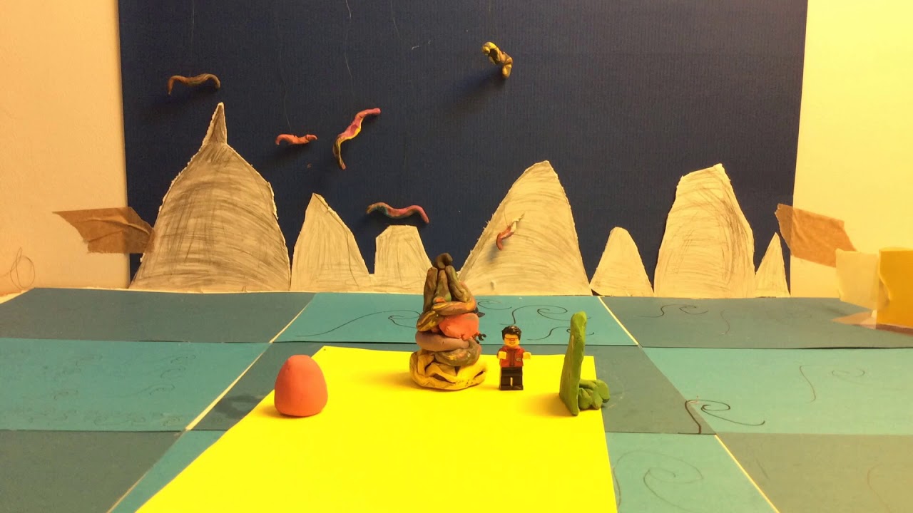 Plasticine and Lego figures in a landscape designed from paper.