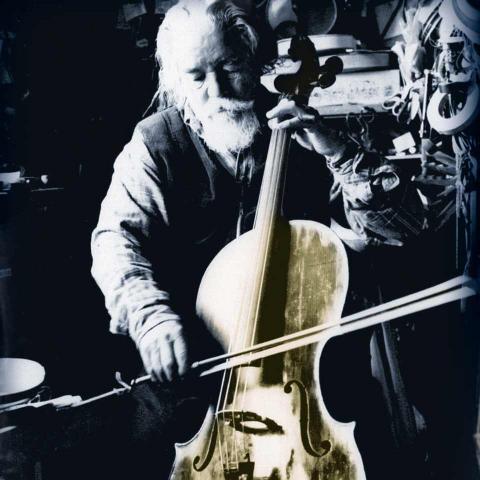 Book cover showing an elderly, white-haired, bearded gentleman playing the cello.