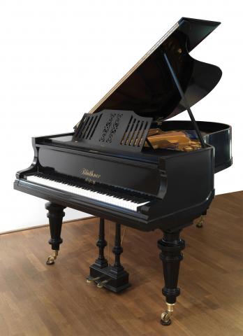 Black grand piano with its lid open