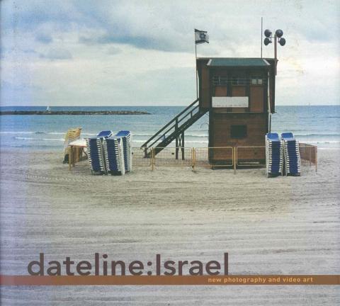 Book cover of “Dateline: Israel”: a small wooden building next to the beach, the building is flying the flag of Israel and is surrounded by stacks of beach chairs.