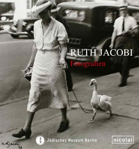 Catalouge cover for exhibition “Ruth Jacobi”: black and white photograph of a woman with a large hat walking a white duck on a leash.