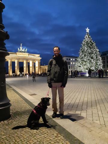 A man with a dog on Pariser Platz in Berlin