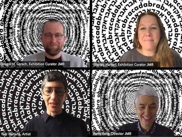 Film still of a video conference. It shows as split screen four people, each sitting in front of a black and white background consisting of the lettering “Abracadabra” in Latin and Hebrew letters arranged in concentric circles.