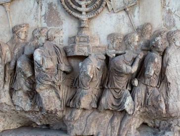 Damaged relief: a group of men carrying a Hanukkah candelabrum on their shoulders.