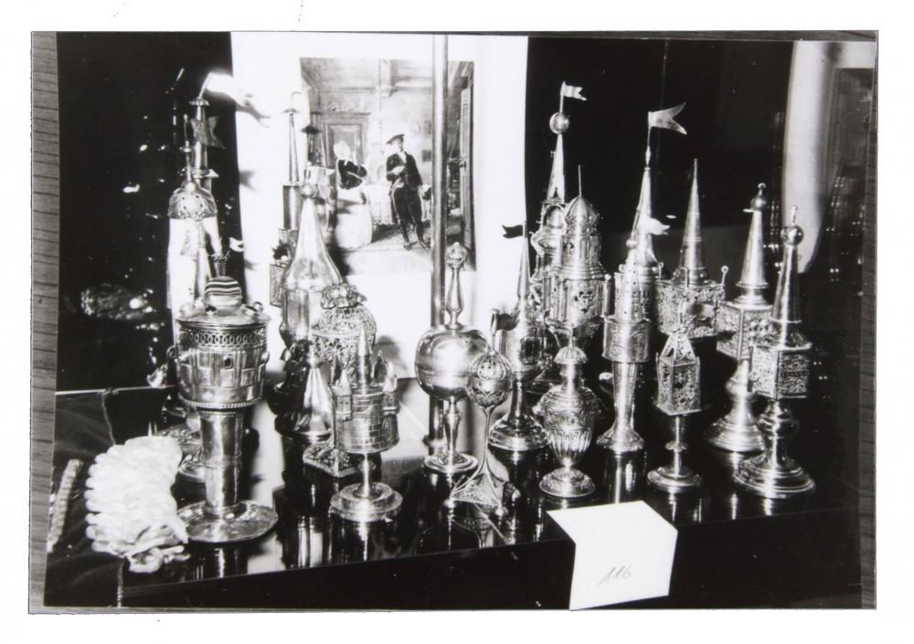 Black and white photograph with Besamim cans in a showcase