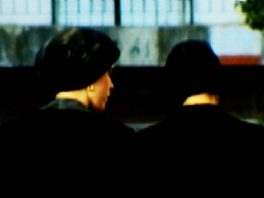 Two women with head coverings (view from behind)