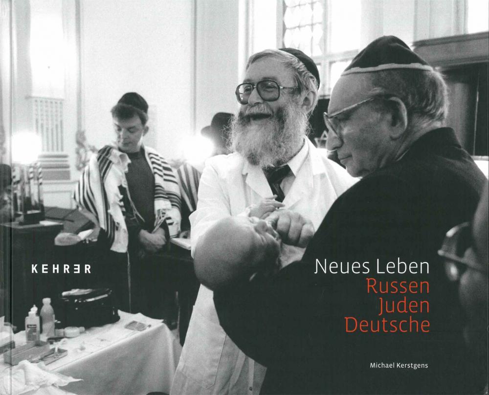 Book Cover for "Russen - Juden - Deutsche": black and white photograph of two older men wearing Yamaka holding a small crying baby