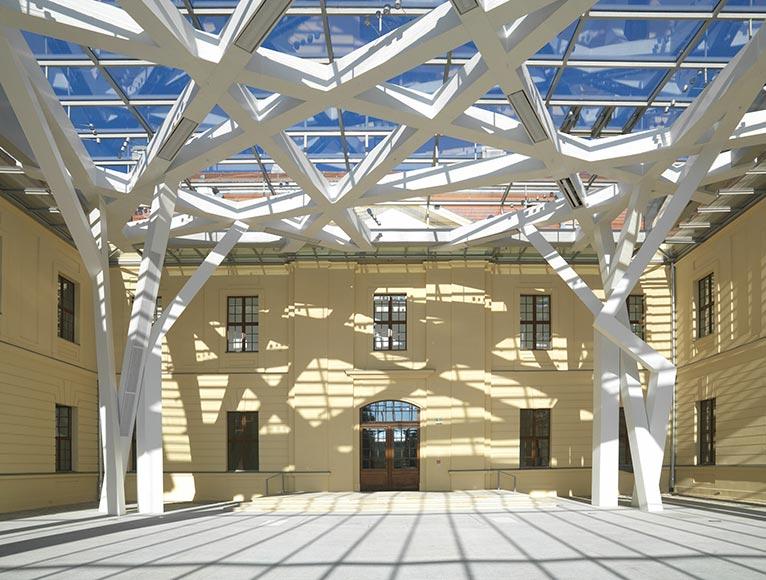 View from below of the roof structure of the glass courtyard.