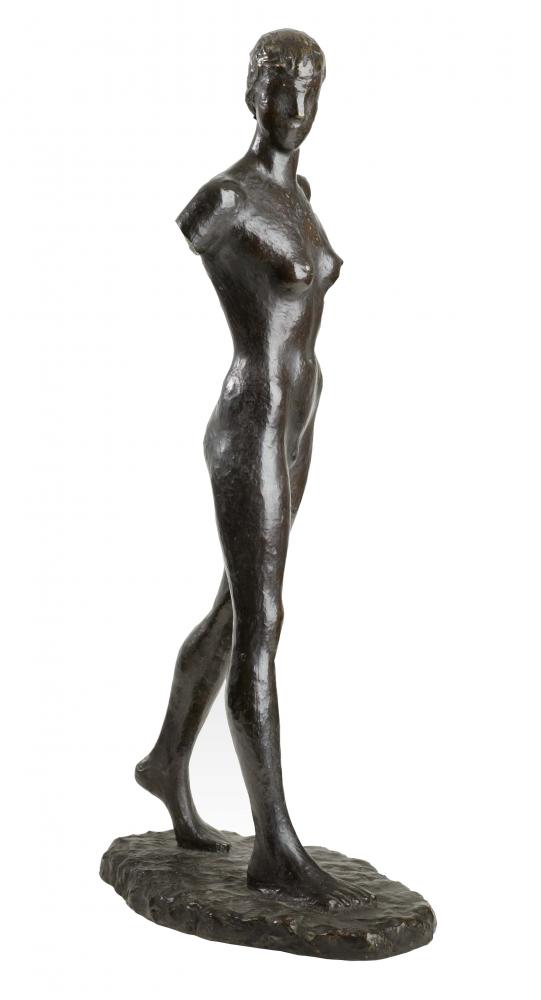 Sculpture of a younger naked woman, only the base of the arms is present, the right leg is shown striding forward. The torso and head are slightly turned to the right.