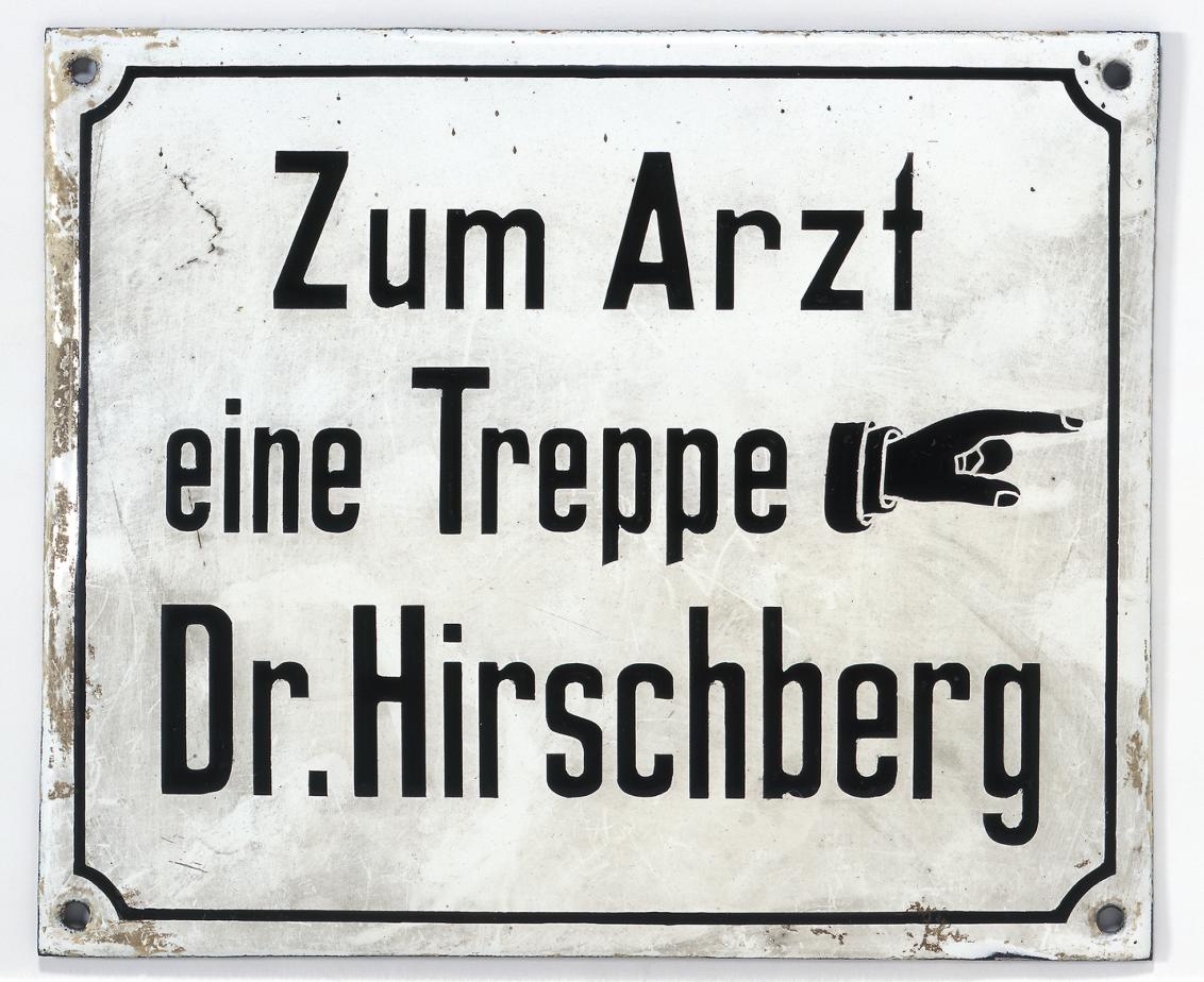 Dr. Hirschberg's office sign with a hand symbol directing patients towards stairs to the right