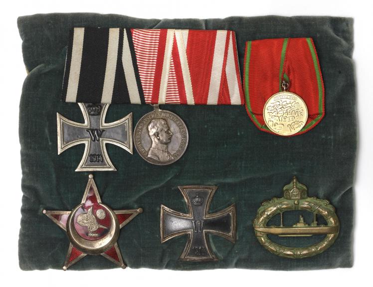 Six military medals on a velvet cushion