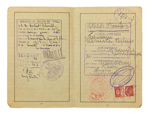 Open passport with handwritten entries and adhesive and ink stamps.