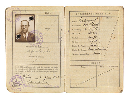 Open passport with photo, stamps and handwritten entries