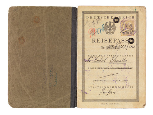 Open passport with handwritten entries and stamps