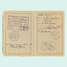 Open passport with handwritten entries and stamps