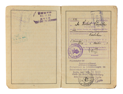 Open passport with handwritten entries and stamps