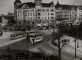 Photo from above of buildings, square, and buses 