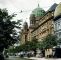 Colored historical photo with street view and synagogue